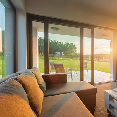 Sunset in modern living room Sunset in modern living room interior with big comfortable sofa