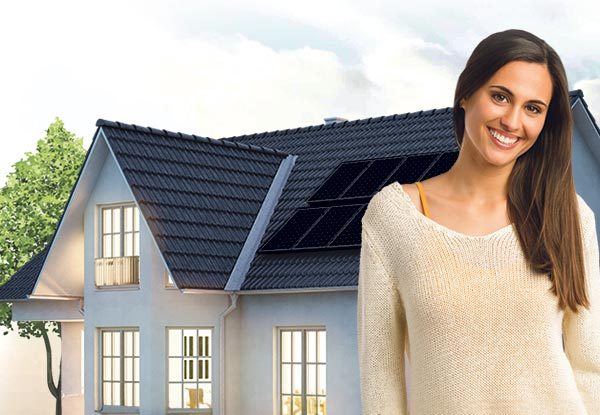 Woman in front of house with solar panels