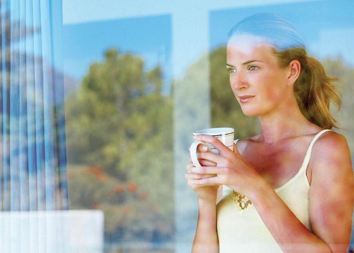 Woman admiring her new glass with a cup of tea