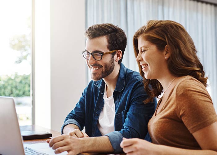 Happy couple applying for loan